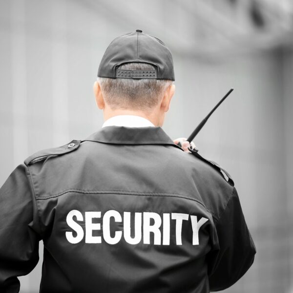 Male,Security,Guard,Using,Portable,Radio,Outdoors