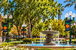 Bright daytime panoramic view of Old Towne Orange, Plaza Square fountain, historic buildings and Chapman University in Orange, California.