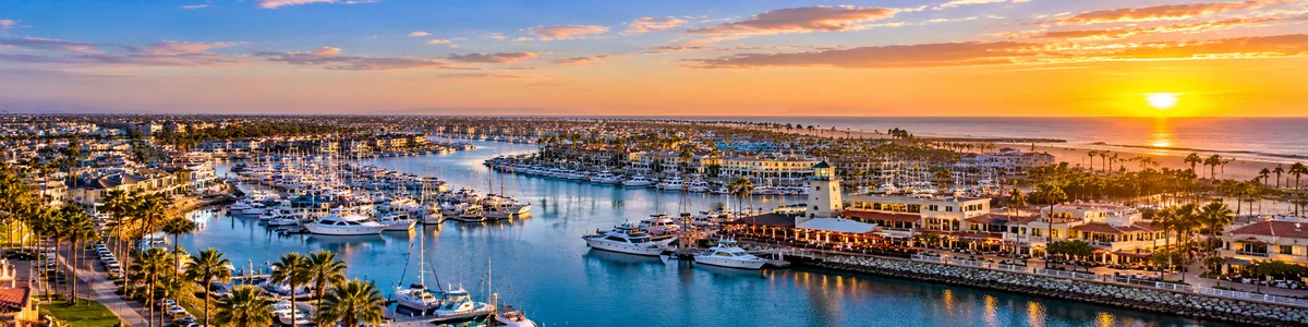 oxnard-security-guard-services-hero (1) Aerial panoramic illustration of Channel Islands Harbor, boats, waterfront neighborhoods, and Pacific Ocean at sunset in Oxnard, Ventura County, California.