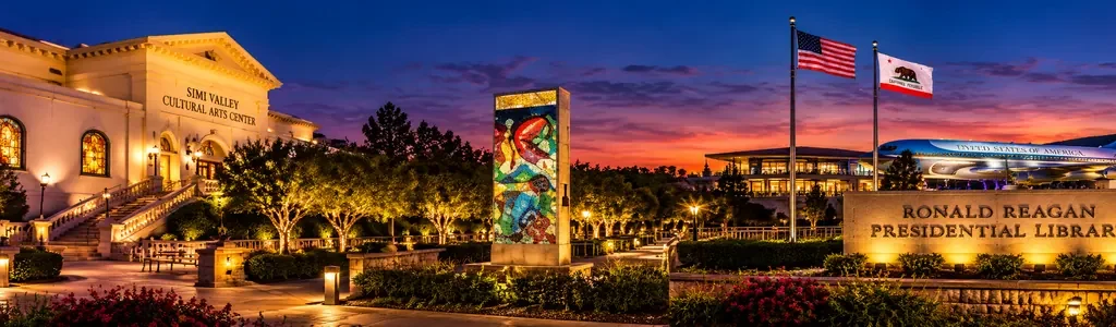Nighttime panoramic illustration featuring the illuminated Simi Valley Cultural Arts Center and Ronald Reagan Presidential Library in Simi Valley, California.
