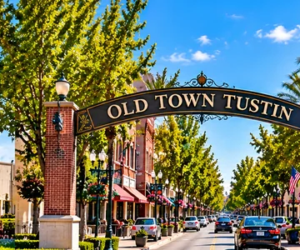 Bright daytime panoramic illustration of Tustin Hangars, historic Old Town Tustin and The District at Tustin Legacy in Tustin, Orange County, California.